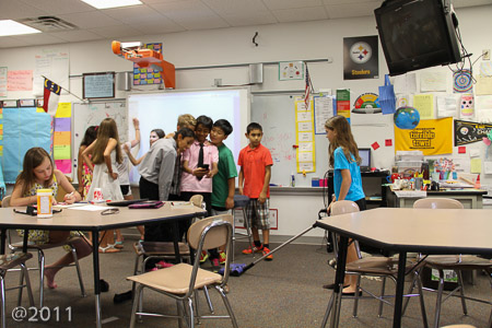 Ella vacuuming the classroom one last time for Mr. Werner