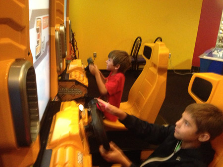 Sam and Jonah at the game room at the bowling alley