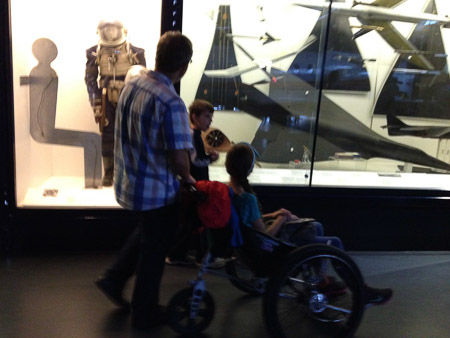 Ella in a wheelchair because of her hurt foot