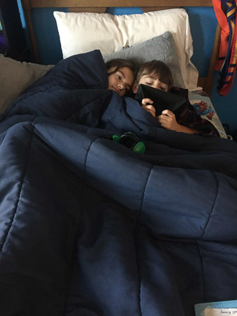 snuggling siblings