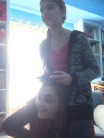 Ella playing video games on Grace's shoulders?...